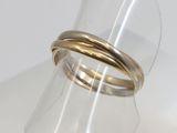 a close up of a gold ring on a clear ring holder
