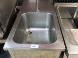 a sink and a dishwasher in a commercial kitchen