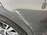 a close up of a car ' s paint job on the side of the car