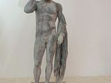 statue of a man holding a fish in his right hand
