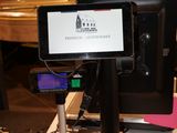 a cell phone sitting on top of a desk with a monitor