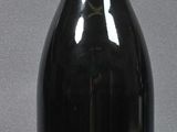 a black bottle with a red top on a table