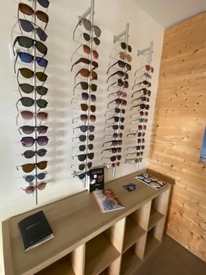 a display of sunglasses on a wall in a store