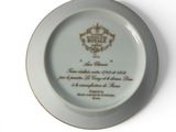 a white plate with a gold and white design on it
