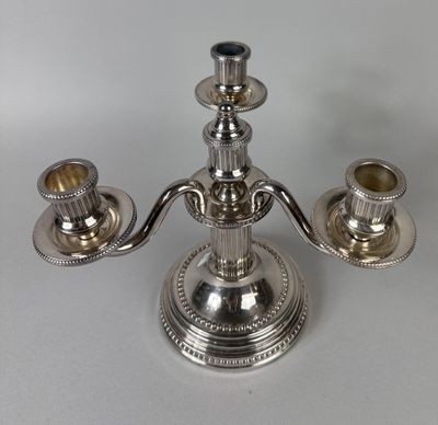 an image of a silver candle holder on a table