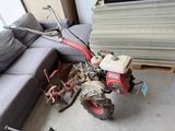 a small red tractor that is sitting on the floor
