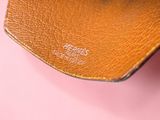 the inside of a brown leather wallet with a brown leather strap