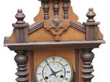 a wooden clock that is on display on the wall