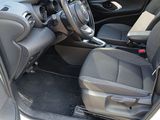 the interior of a white car with black seats and a steering wheel