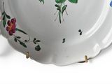 a plate with flowers painted on it on a white surface