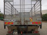 a truck with a cage on the back parked in a parking lot