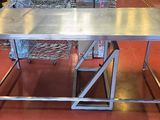 a large stainless steel table in the middle of a room