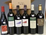 several bottles of wine are lined up in a row on a counter