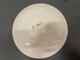 a white plate with writing on it sitting on a table