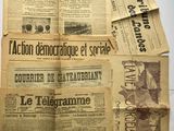 several old newspapers are stacked on top of each other on a table