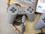 two video game controllers sitting on a basket next to a video game