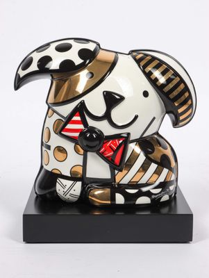 statue of a dog wearing a hat and a bow tie on a black base