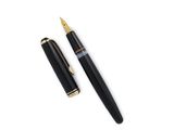 a close up of a pen and a ballpoint pen on a white surface