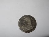 a close up of a coin on a table with a white background