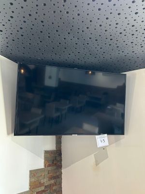 a flat screen tv mounted on the wall in the corner of a room