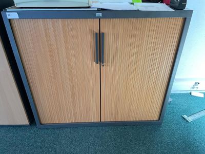 a cabinet that has a printer on top of it