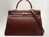 a brown leather handbag on a white background