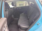 the back seats of a blue car are empty in the car