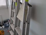a ladder that is leaning against a wall in a room