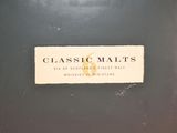 a label that says classic malts on the back of a suitcase