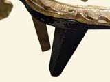 a close up of a gold colored bench with an elephant on it ' s back