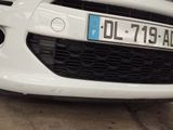 a white car with a blue license plate on it
