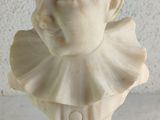 a white bust of a child with a collar around his neck