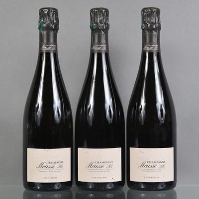 three bottles of wine are lined up on a table