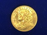 a close up of a gold coin on a blue surface