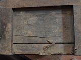 an old wooden box with a pair of scissors in it