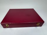 an image of a red box with gold handles on a white surface