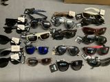 many pairs of sunglasses sitting on a table