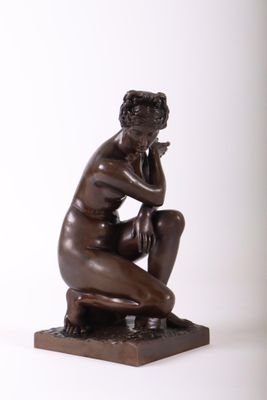 bronze statue of a man sitting on a stool with his hand on his chin