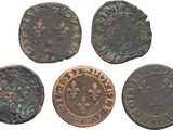 a group of four ancient coins with fleures and fleures on them