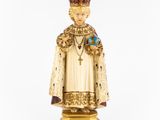 figurine of a statue of a man with a crown and a bird