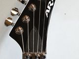 a close up of an electric guitar with a black neck