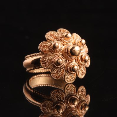 a close up of a gold ring on a black surface