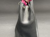 black leather handbag with a pink ribbon on the handle