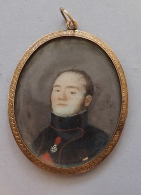 an old picture of a man in a military uniform in a gold frame