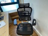 a desk with a chair and a computer on it