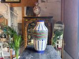 a blue and white vase sitting on top of a table