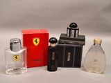 two bottles of perfume sitting next to each other on a white surface