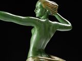 statue of a woman holding a tennis racquet on a black background