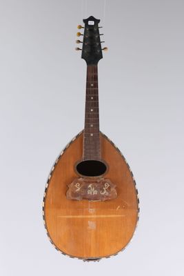 a guitar hanging from the ceiling in a room