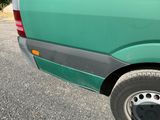 a green van parked on the side of the road